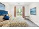 Cozy bedroom features a plush bed with floral bedding and soft natural light from the window at 619 Vega Nw St, Concord, NC 28027