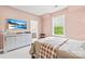 Bright bedroom features neutral walls, large window, modern dresser, and TV, creating a relaxing retreat at 619 Vega Nw St, Concord, NC 28027