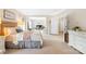 Spacious bedroom with neutral tones features a sitting area, bedroom furnishings, and large windows at 619 Vega Nw St, Concord, NC 28027