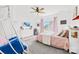 Bright bedroom with modern decor, ceiling fan, large windows, and whimsical chair swing, for relaxation at 619 Vega Nw St, Concord, NC 28027