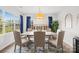 Elegant dining room with large windows, stylish curtains, and seating for six at 619 Vega Nw St, Concord, NC 28027
