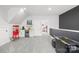 Spacious game room with wet bar, popcorn machine, games, and modern decor, perfect for entertaining at 619 Vega Nw St, Concord, NC 28027