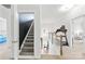 Spacious hallway with staircase, carpet runner, railing, and partial view of downstairs area with equipment at 619 Vega Nw St, Concord, NC 28027