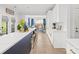 Bright kitchen featuring white cabinets, stainless steel appliances, and a view into the dining area at 619 Vega Nw St, Concord, NC 28027