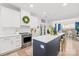 Modern kitchen with white cabinets, quartz countertops, stainless steel appliances, and island seating at 619 Vega Nw St, Concord, NC 28027