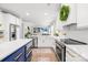 Modern kitchen with stainless steel appliances, white cabinets, and an open layout to the living room at 619 Vega Nw St, Concord, NC 28027