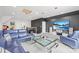 Spacious living room area with plush blue seating and a modern table, next to large TV at 619 Vega Nw St, Concord, NC 28027