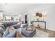 Bright and open living space with a large sectional sofa, hardwood floors, and modern decor at 619 Vega Nw St, Concord, NC 28027