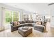 Open-concept living area with a large sectional sofa, natural light, and view into modern kitchen at 619 Vega Nw St, Concord, NC 28027