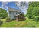 Expansive backyard with lush grass, mature trees, and screened in porch at 6723 Joliette Ln, Charlotte, NC 28277