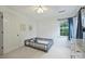 Comfortable bedroom with bright light, gray dresser, and ceiling fan at 6723 Joliette Ln, Charlotte, NC 28277