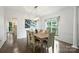 Bright dining room with wood floors, modern light fixture, and elegant decor at 6723 Joliette Ln, Charlotte, NC 28277