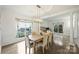 Spacious dining room with wood floors, large windows, and modern lighting at 6723 Joliette Ln, Charlotte, NC 28277