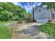 Concrete driveway with basketball hoop leading to a two-car garage, fenced with manicured landscaping at 6723 Joliette Ln, Charlotte, NC 28277
