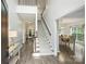 Bright foyer with staircase, wood floors, and views into dining and living areas at 6723 Joliette Ln, Charlotte, NC 28277