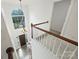 Bright foyer with soaring ceilings, grand chandelier, hardwood floors, staircase, and large arched window at 6723 Joliette Ln, Charlotte, NC 28277