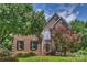 Stately brick home with manicured lawn, dark shutters, and mature trees enhances curb appeal at 6723 Joliette Ln, Charlotte, NC 28277