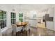 Bright eat-in kitchen with white cabinets, stainless steel appliances, and a round dining table at 6723 Joliette Ln, Charlotte, NC 28277