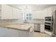 Modern kitchen featuring granite countertops, stainless appliances, and ample white cabinetry at 6723 Joliette Ln, Charlotte, NC 28277