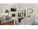 Bright living room featuring a fireplace, ceiling fan, and French doors to the outdoors at 6723 Joliette Ln, Charlotte, NC 28277