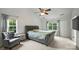 Calming main bedroom with neutral tones, carpet, a ceiling fan, and plenty of natural light from the windows at 6723 Joliette Ln, Charlotte, NC 28277