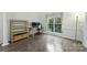 Bright home office with wood floors, large window, and built-in shelving at 6723 Joliette Ln, Charlotte, NC 28277