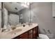 Well-lit bathroom featuring a double sink vanity with cherry wood cabinets and a large mirror at 735 Shuttles Way, Fort Mill, SC 29715