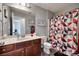 This bathroom features a geometric-patterned shower curtain, framed mirror, toilet, and vanity at 735 Shuttles Way, Fort Mill, SC 29715