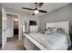 This bedroom with connecting bathroom has a ceiling fan, TV, dresser, and a comfortable queen-sized bed at 735 Shuttles Way, Fort Mill, SC 29715