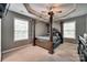 This is a bedroom featuring a dark wood framed bed with dark wood trim and light grey walls at 735 Shuttles Way, Fort Mill, SC 29715