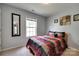 Neutral bedroom with window, queen bed, stylish bedding and a mirrored wall decoration at 735 Shuttles Way, Fort Mill, SC 29715