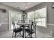 Bright dining area with marble table, sliding door, and stylish light fixture at 735 Shuttles Way, Fort Mill, SC 29715