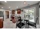 Bright dining area with marble table, sliding door, and adjacent to a modern kitchen at 735 Shuttles Way, Fort Mill, SC 29715