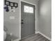 Modern entryway featuring gray walls, light-colored wood floors, and a stylish gray door with decorative glass at 735 Shuttles Way, Fort Mill, SC 29715