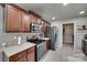 Bright kitchen features stainless steel appliances, dark wood cabinetry, and stylish countertops at 735 Shuttles Way, Fort Mill, SC 29715