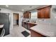 Modern kitchen with stainless steel appliances, dark wood cabinets, and tiled flooring at 735 Shuttles Way, Fort Mill, SC 29715