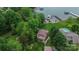 An aerial view of a charming home with lush landscaping, access to a private dock, and stunning lake views at 7942 Vista View Dr, Sherrills Ford, NC 28673