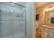 Bathroom with a glass-enclosed shower, granite vanity, and warm lighting for a spa-like experience at 7942 Vista View Dr, Sherrills Ford, NC 28673