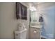 Bathroom featuring a granite vanity, a decorative light fixture, and a nearby toilet with paper at 7942 Vista View Dr, Sherrills Ford, NC 28673