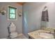 Bright half bath featuring a granite countertop, decorative floral accents, and well-lit space at 7942 Vista View Dr, Sherrills Ford, NC 28673