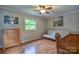 Bedroom featuring wood-look floors, natural light, and a cozy futon couch at 7942 Vista View Dr, Sherrills Ford, NC 28673