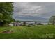 Expansive lake view with a well-manicured lawn, dock, and fire pit, perfect for outdoor entertaining at 7942 Vista View Dr, Sherrills Ford, NC 28673