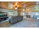 Spacious living room with wood paneling, fireplace, and adjacent dining area, perfect for relaxing and entertaining at 7942 Vista View Dr, Sherrills Ford, NC 28673