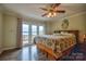 Charming main bedroom with lake views, balcony access, and stylish wood flooring, creating a serene retreat at 7942 Vista View Dr, Sherrills Ford, NC 28673