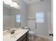 Bright bathroom with ample counter space, framed mirror, tiled shower, and accessible grab bar at 968 Autumn Glen Ct, Clover, SC 29710