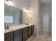 Ensuite bathroom with double sink vanity, large mirror, and walk-in closet, offering ample storage at 968 Autumn Glen Ct, Clover, SC 29710