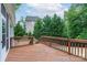 A wooden deck overlooks the backyard with mature trees and a glimpse of the home's exterior at 968 Autumn Glen Ct, Clover, SC 29710