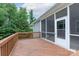 Wooden deck with grey siding, a door to the screened porch, and a view of lush greenery at 968 Autumn Glen Ct, Clover, SC 29710