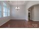Dining room featuring hardwood floors, a modern chandelier, and arched doorway at 968 Autumn Glen Ct, Clover, SC 29710