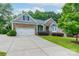 Charming home featuring a stone and siding facade, well-manicured lawn, and a two-car garage at 968 Autumn Glen Ct, Clover, SC 29710